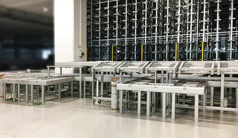 Picking station  in a Warehouse at a high bay storage for totes. Italy